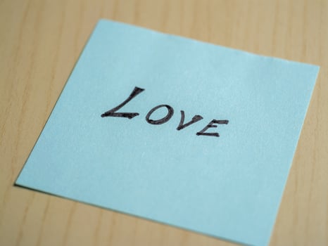 Love note home office desk personal message minimalist environment close-up view emotion expression photo