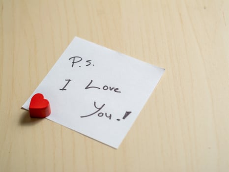 Close-up view of heartfelt love note with red heart personal message and emotional connection photo