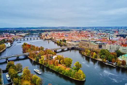Aerial view of cityscape of Prague with colorful autumn trees on island on Vltava river. Architecture of Praha, Czech Republic photo