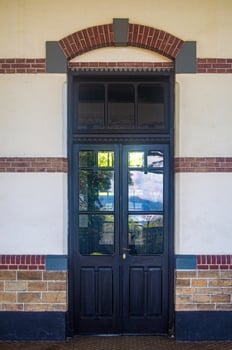 Vintage wooden door with glass panels and brick arch, perfect for historical architecture themes and classic design projects photo