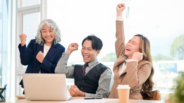 A group of diverse Asian businesspeople celebrating their project success together. photo