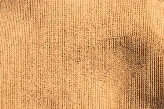 Beach towel imprint on sand. Sandy background. photo