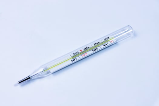 Medical mercury thermometer, white background. Copy space photo