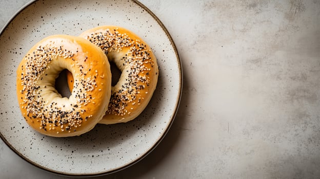 Round plate with a bagel cut in half, each side evenly spread, food setting photo