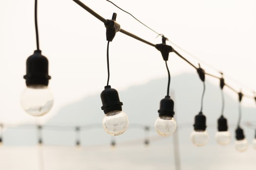 Several light bulbs hanging from a wire photo