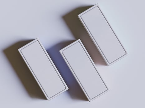 Three white boxes on a white surface photo