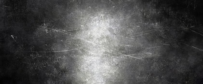 Dark grunge texture featuring subtle scratches and a luminous central highlight, perfect for backgrounds. photo