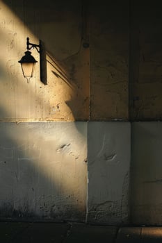 Vintage Street Lamp Casting Shadows on Weathered Wall in Soft Evening Light photo