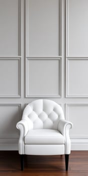 Elegant white chair against a minimalist gray wall photo