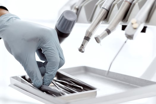 Closeup Shot Of Dentists Hand In Blue Glove Taking Sterile Stomatological Tools Out Of Case Before Dental Treatment In Modern Clinic, Unrecognizable Doctor Using Professional Medical Equipment photo