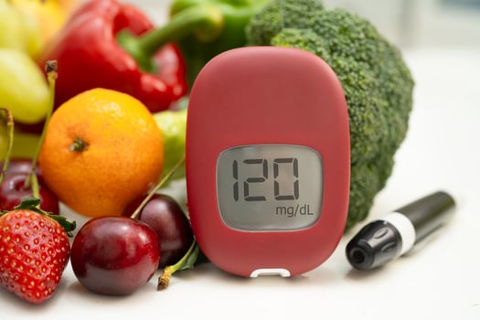 Glucose meter with vegetable and fruit for check sample blood sugar level to treatment diabetes. photo