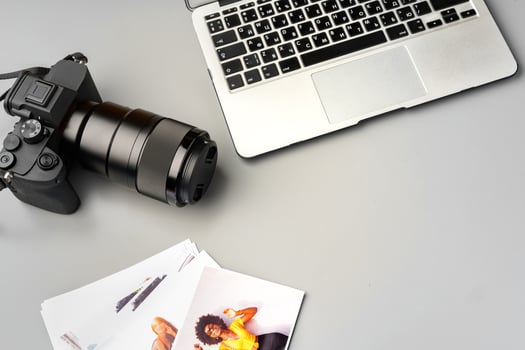 Laptop and camera on the table close up. Printing photos
