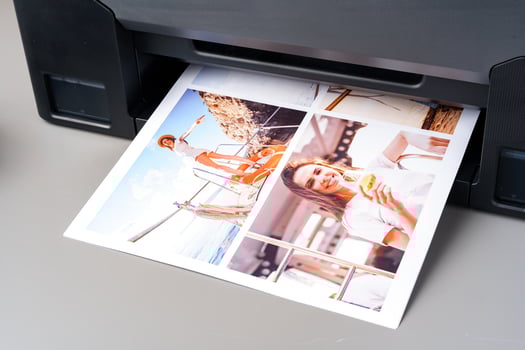 Modern laser printer printing color photos of women close up