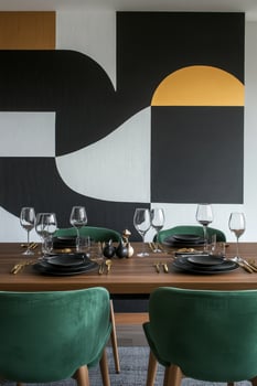 Modern dining area featuring bold wall art and stylish green chairs in a contemporary home photo