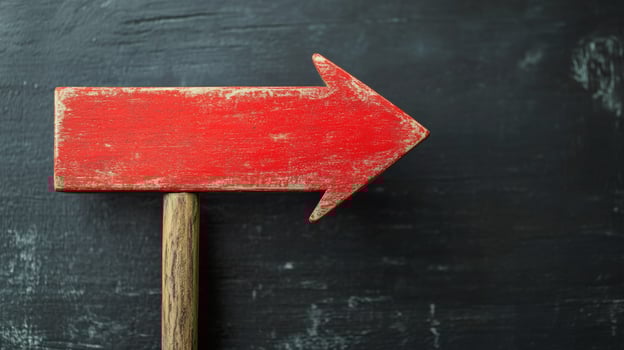 Empty red wooden sign on a dark textured surface ready for messages or directions photo