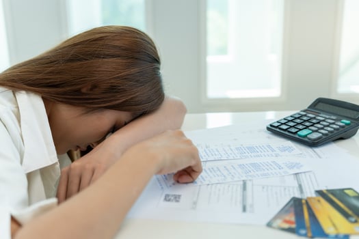 Stressed and headache asian woman with large bills or invoices no money to pay to expenses and credit card debt. shortage, Financial problems, mortgage, loan, bankruptcy, bankrupt, poor, empty wallet photo