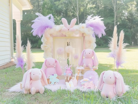 Pastel pink bunnies, pampas grass, and floral backdrop for a whimsical outdoor photoshoot. photo