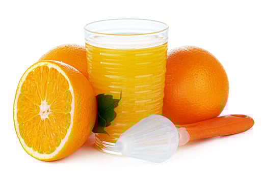 Glass of orange juice with squeezer isolated on white photo
