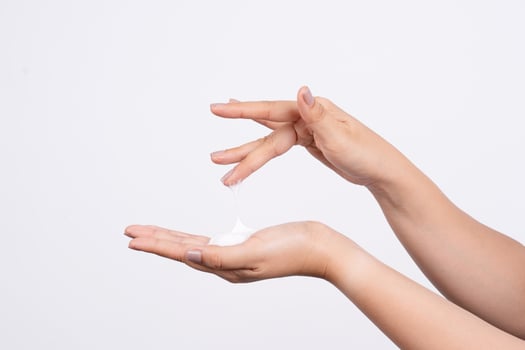A woman's hand placing a lump of fine foam on her palm photo