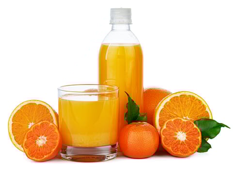 Bottle of fresh orange juice isolated on white photo