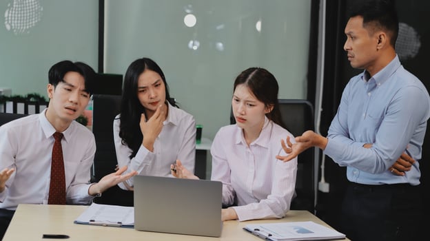 Frustrated upset multiracial business team people sad with bad work result in report disappointed in corporate bankruptcy failure crisis worried of paperwork problem sit at table at office meeting photo