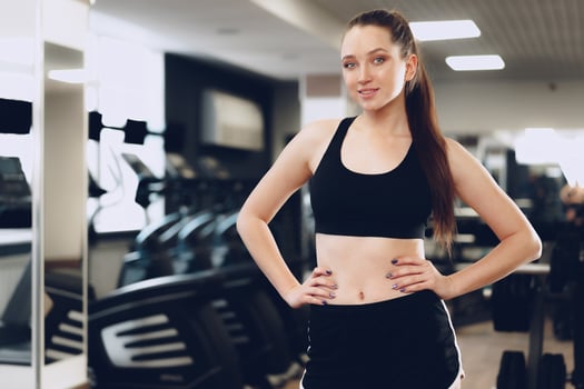 Portrait of a young sporty caucasian woman training in a fitness club photo