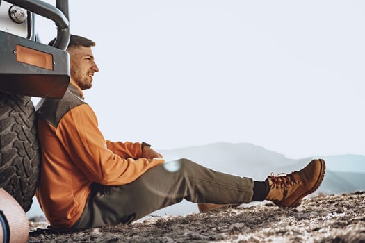 Young male hiker sitting and having a rest on a halt stop photo