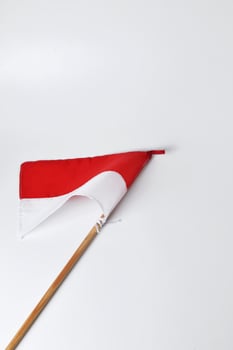 The red and white flag with a wooden pole is a symbol of the Indonesian nation photo