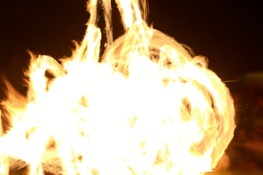 Long exposure shot of moving burning torches and fire photo