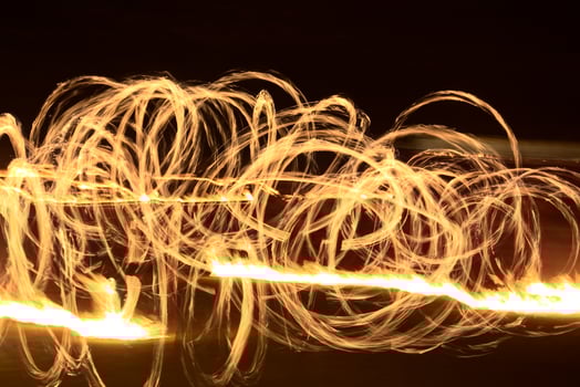 Long exposure shot of moving burning torches and fire photo