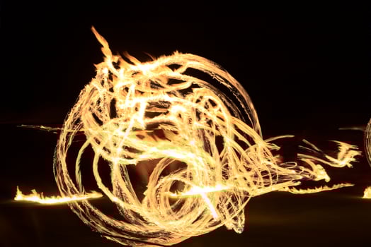 Long exposure shot of moving burning torches and fire photo