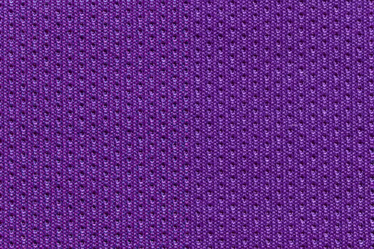 Detailed close up of vibrant purple textile fabric with texture and patterns. photo