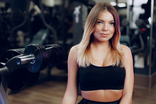 Portrait of a fit young blonde woman in black sport bra photo