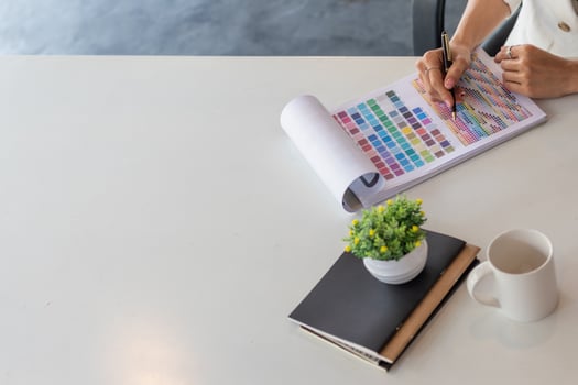 Young designers are choosing color schemes to use in their ux ui website design and working with mobile responsive web developers with ux ui Front End Designer Previewing to make them efficient. photo