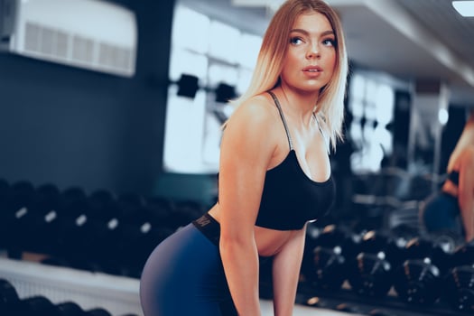 Young beautiful woman in sportswear in a gym photo