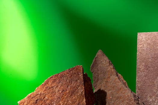 Stone display for product against green background photo