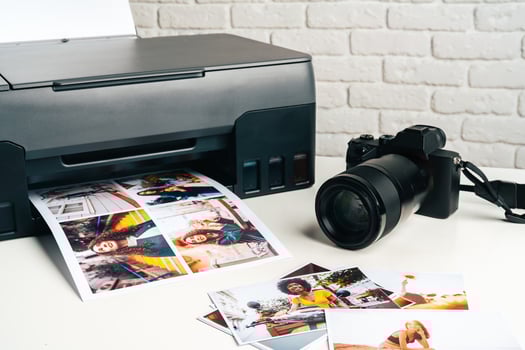 Printer and photo camera on table. Printing photos concept