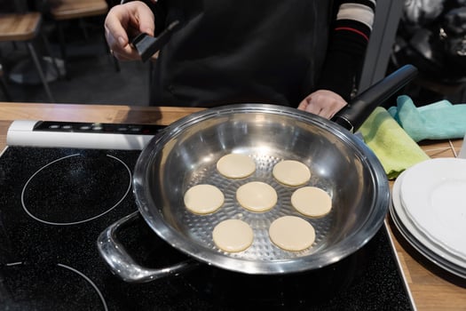 Frying mini pancake cereal in a nonstick frying pan. photo