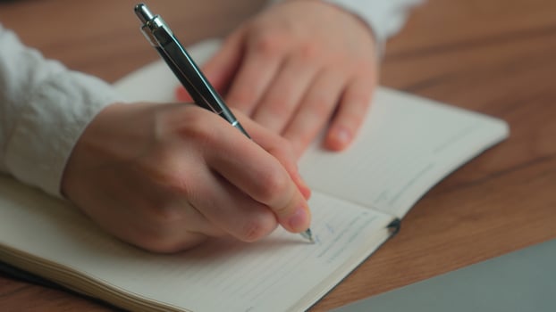 Hands writing notebook planning business tasks Caucasian woman girl female businesswoman student writing notes class exam thoughtful business lady ponder upset pensive analyze at office desk thinking photo