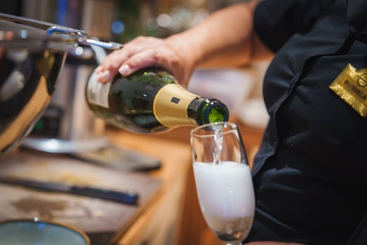 Close Up of Champagne Pouring in Luxury Hotel Setting photo