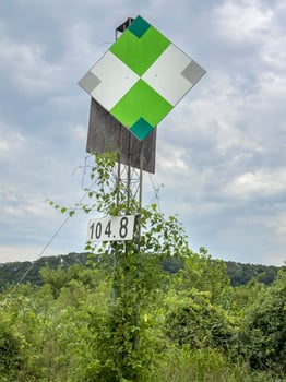 green reflective navigational sign on the right shore of Missouri River photo
