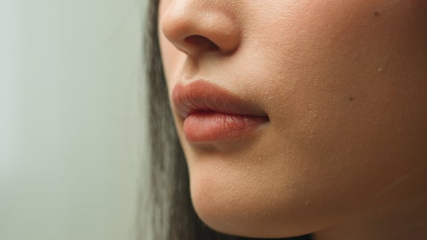Extreme close up mouth female woman unrecognizable girl face details Asian chinese lady sexy seductive lips plastic surgery health care beauty procedure makeup cosmetics lipstick smile cropped shot photo