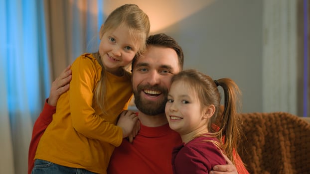 Caucasian happy family bonding affectionate father daughters kids dad parent cuddling little girls at home evening parenting love joyful hug children smile adoption custody medical health insurance photo
