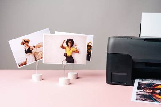 Modern laser printer printing color photos of women close up