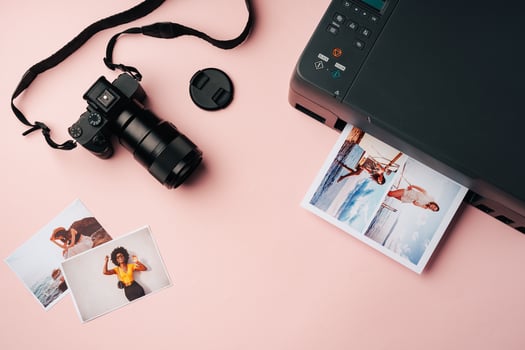 Printer and photo camera on table. Printing photos concept