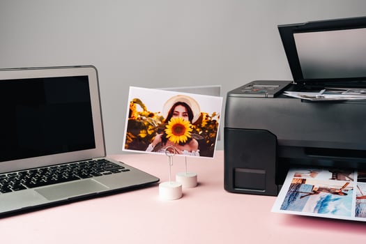 Computer laptop and printer on table. Printing photos