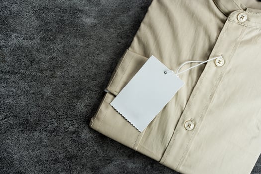 Neutral colored clothing items with paper label photo