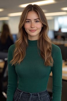 A confident young female entrepreneur smiling warmly while looking directly at the camera in a modern workspace. photo