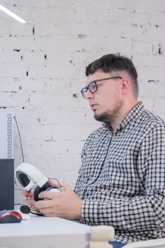 Man Working from Home on Laptop Computer in Stylish Loft Apartment photo