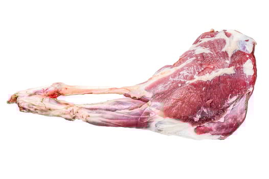 Goat leg with pepper and garlic. Raw Farm meat. Isolated on white background. photo